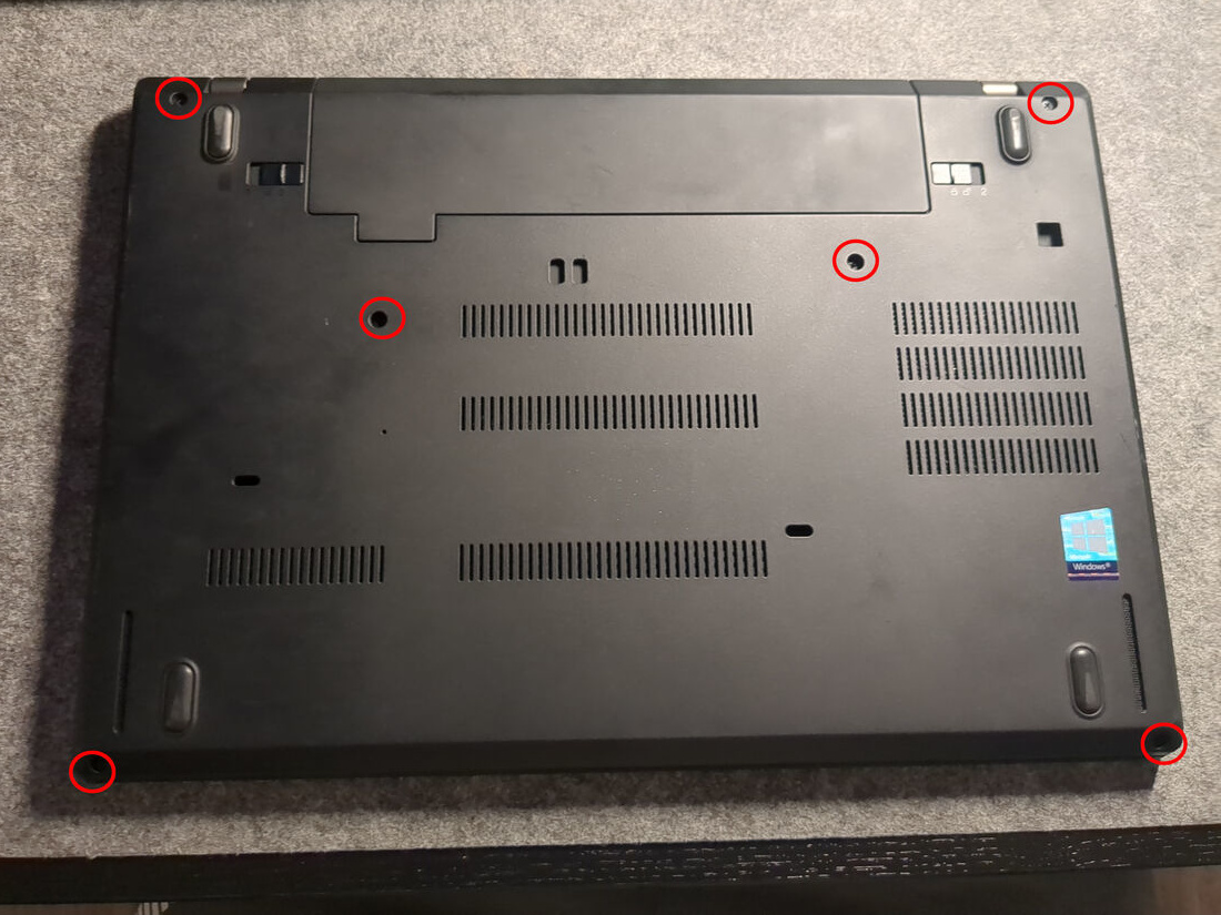 The captive Phillips screws on the bottom of the T480